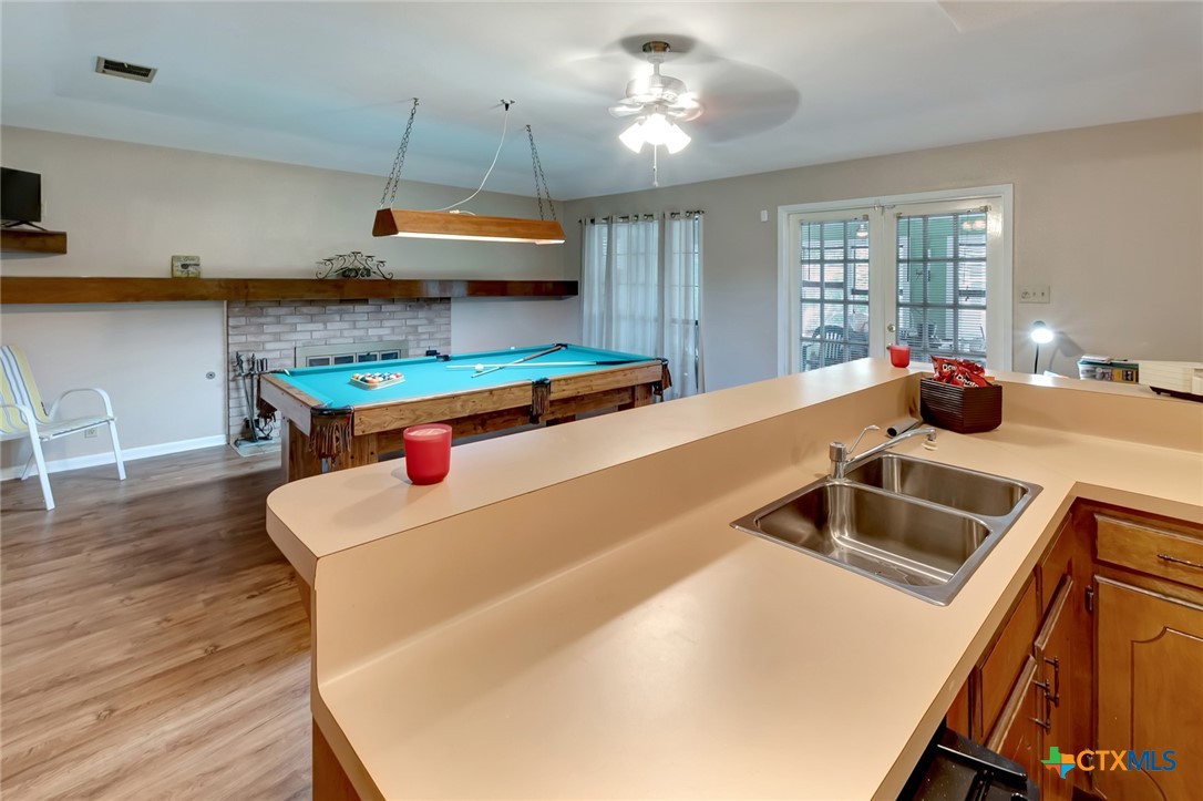 3403 East Rio Grande Street Victoria, TX 77901 - Photo 26 of 41 a kitchen with a sink a stove and chairs