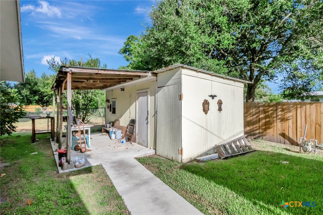 3403 East Rio Grande Street Victoria, TX 77901 - Photo 37 of 41 a view of a backyard with table and chairs and a large tree