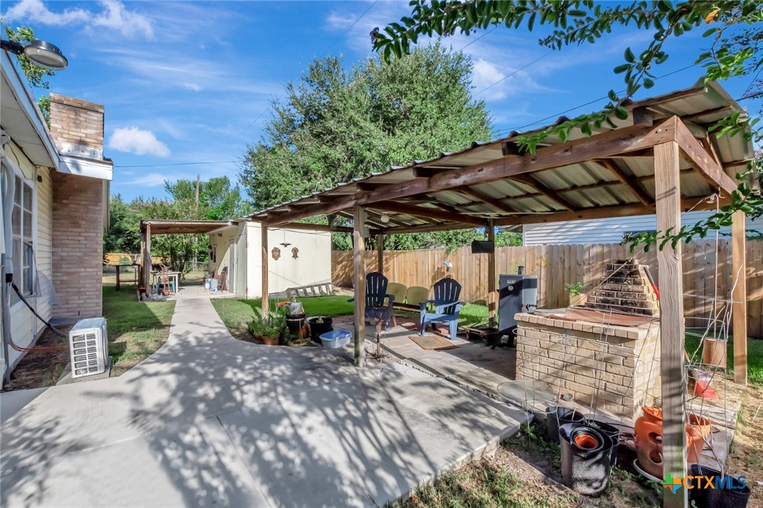 3403 East Rio Grande Street Victoria, TX 77901 - Photo 38 of 41 a view of a patio with table and chairs under an umbrella with a barbeque