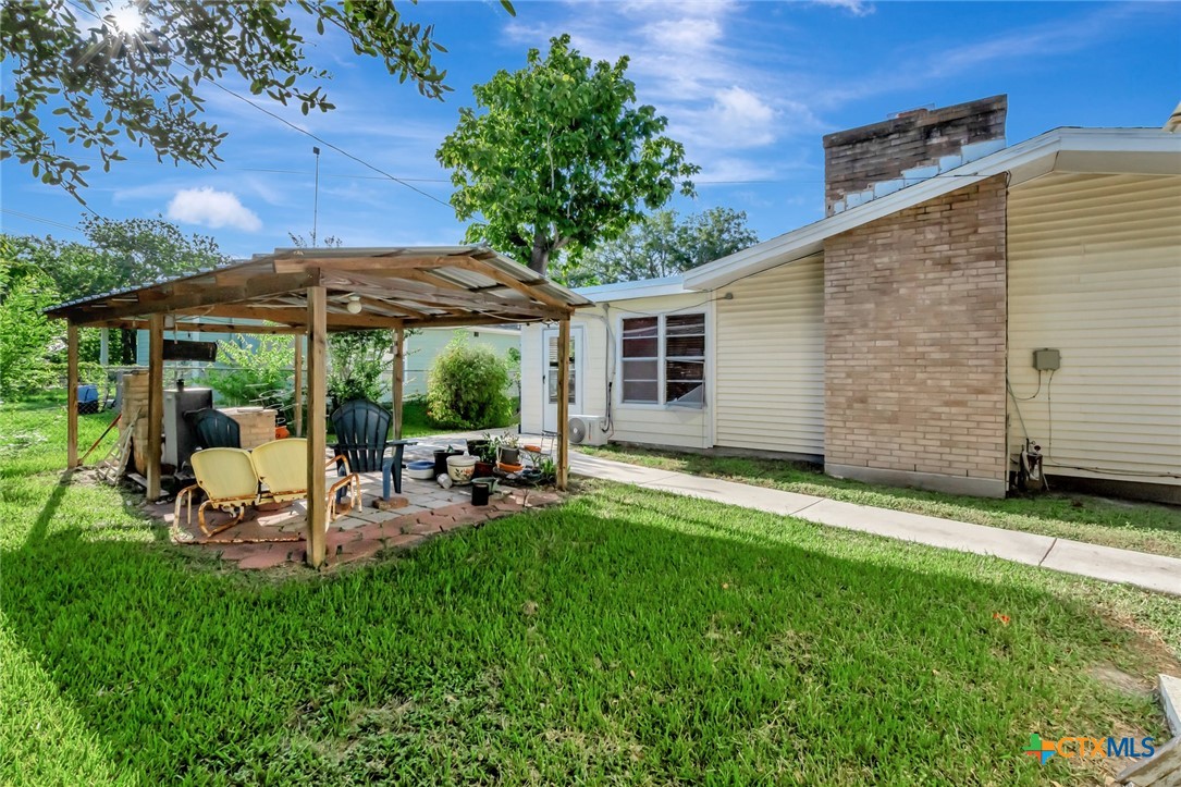 3403 East Rio Grande Street Victoria, TX 77901 - Photo 41 of 41 a view of a backyard with table and chairs under an umbrella