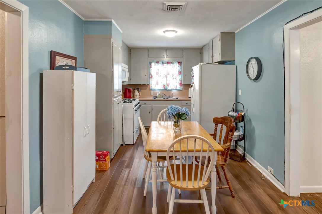 3403 East Rio Grande Street Victoria, TX 77901 - Photo 7 of 41 a view of a dining room with furniture and wooden floor