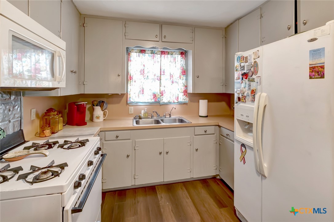 3403 East Rio Grande Street Victoria, TX 77901 - Photo 9 of 41 a kitchen with a refrigerator and a stove