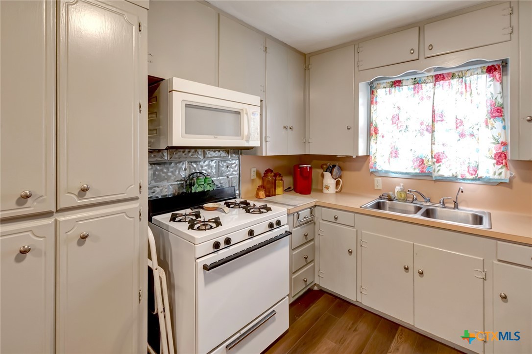 3403 East Rio Grande Street Victoria, TX 77901 - Photo 10 of 41 a kitchen with a stove a sink and a window