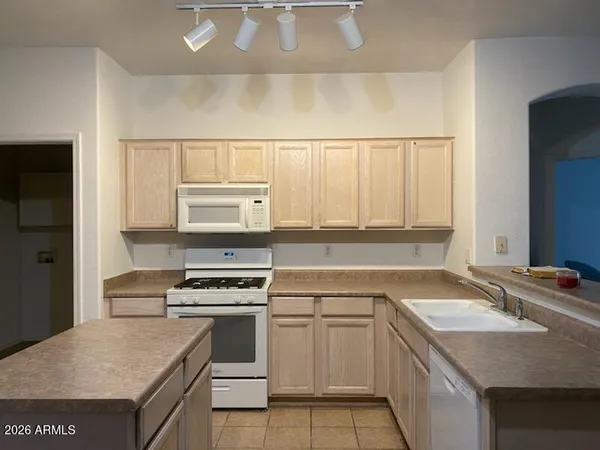 a bathroom with a tub sink and cabinets