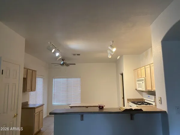 an empty room with windows and chandelier