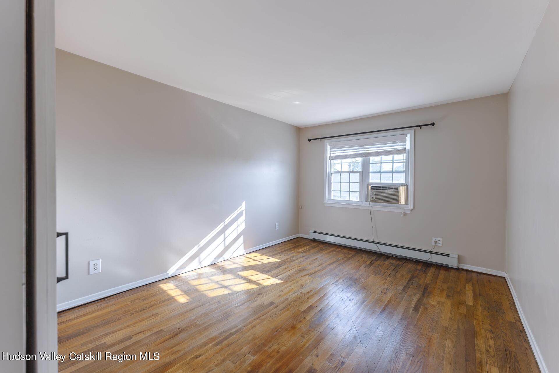 6 Colonial Road, Unit 46 Beacon, NY 12508 - Photo 12 of 19 an empty room with wooden floor and windows