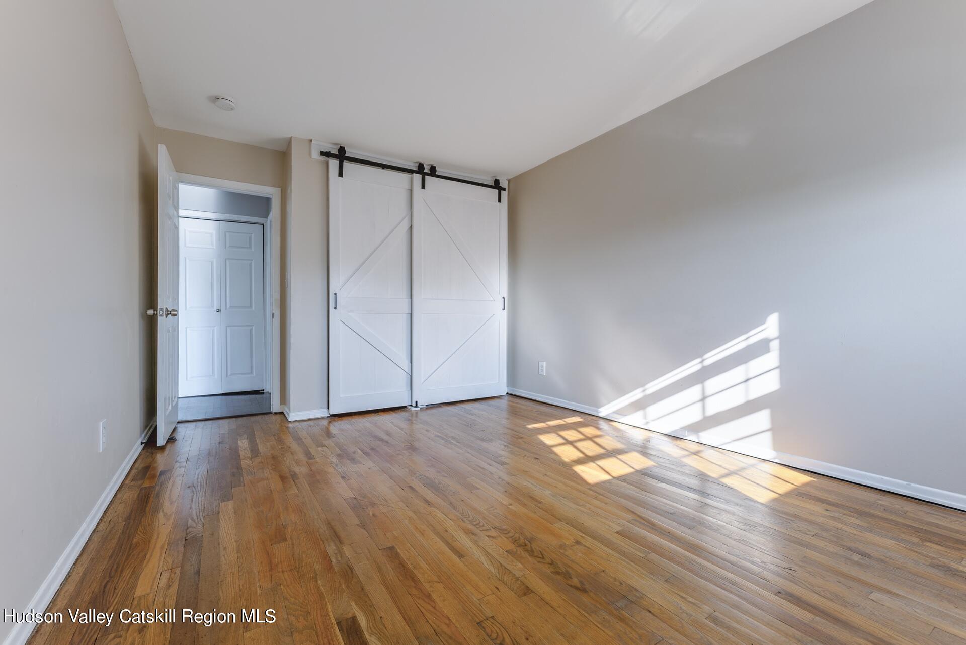6 Colonial Road, Unit 46 Beacon, NY 12508 - Photo 14 of 19 a view of an empty room and wooden floor