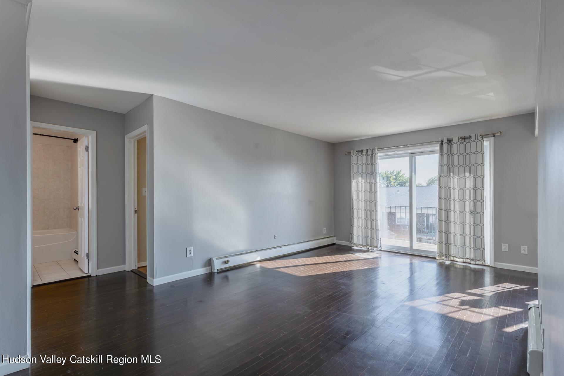 6 Colonial Road, Unit 46 Beacon, NY 12508 - Photo 3 of 19 a view of an empty room with glass door and wooden floor