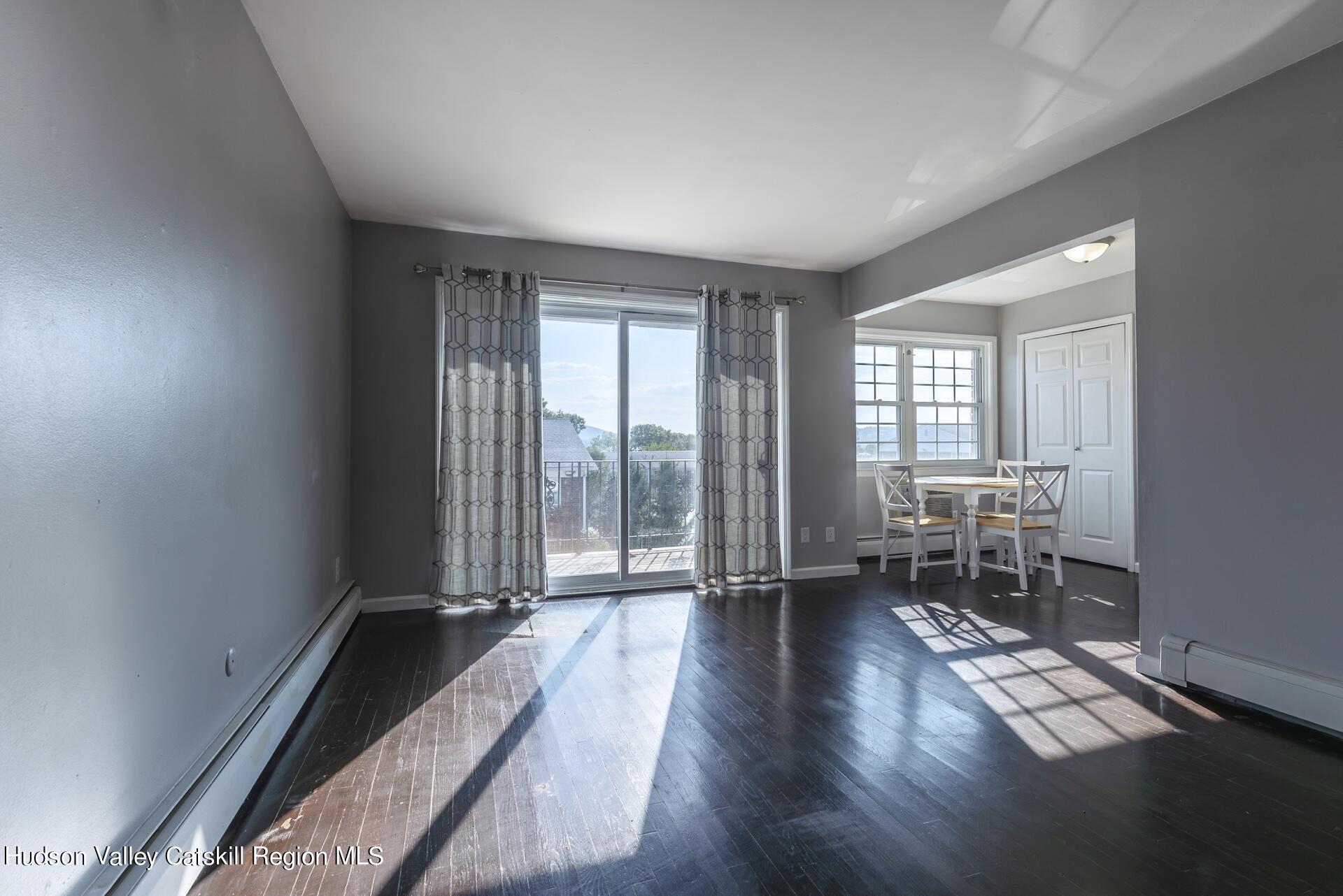 6 Colonial Road, Unit 46 Beacon, NY 12508 - Photo 4 of 19 wooden floor in an empty room with a window