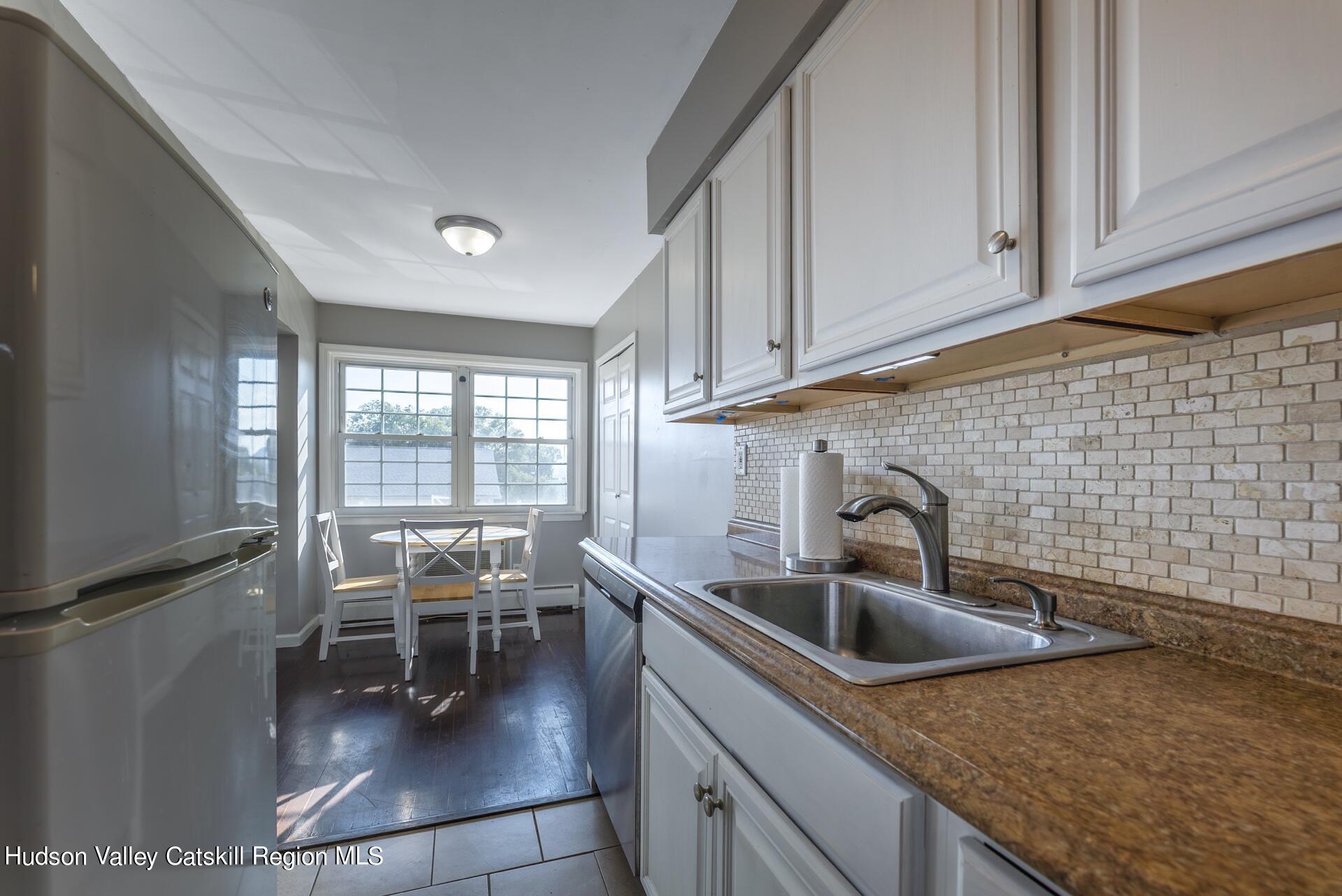 6 Colonial Road, Unit 46 Beacon, NY 12508 - Photo 9 of 19 a kitchen with a sink a table and chairs