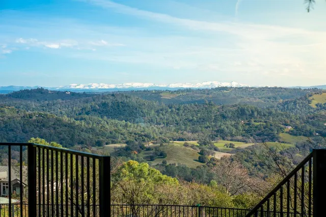 a view of a terrace with yard and mountain view