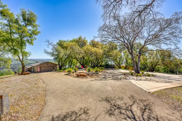 a view of a house with a yard and garage