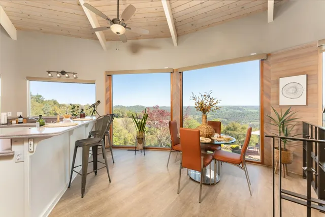 a living room with furniture a rug and a chandelier