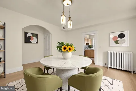 a dining room with furniture and wooden floor