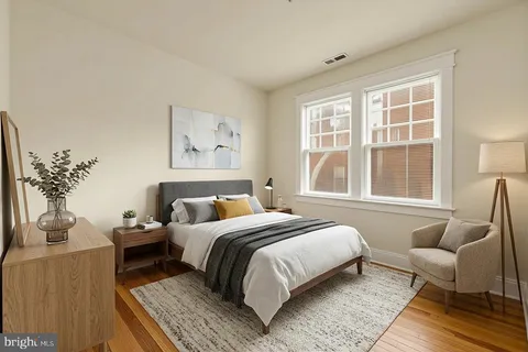 a bedroom with bed and a window