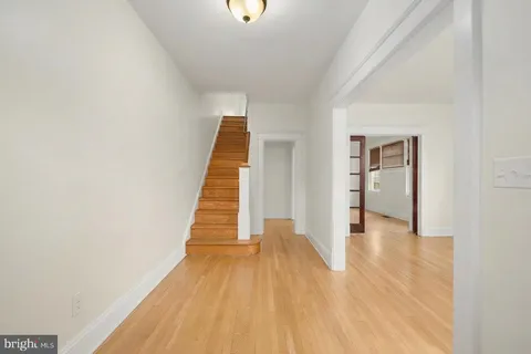 a view of a hallway with wooden floor