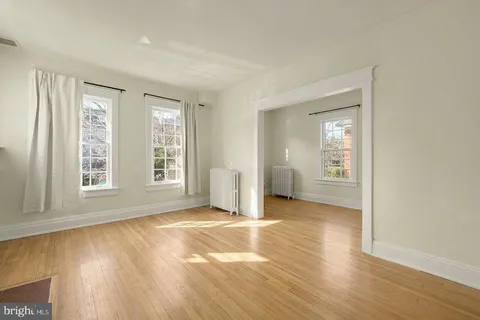 an empty room with windows and closet