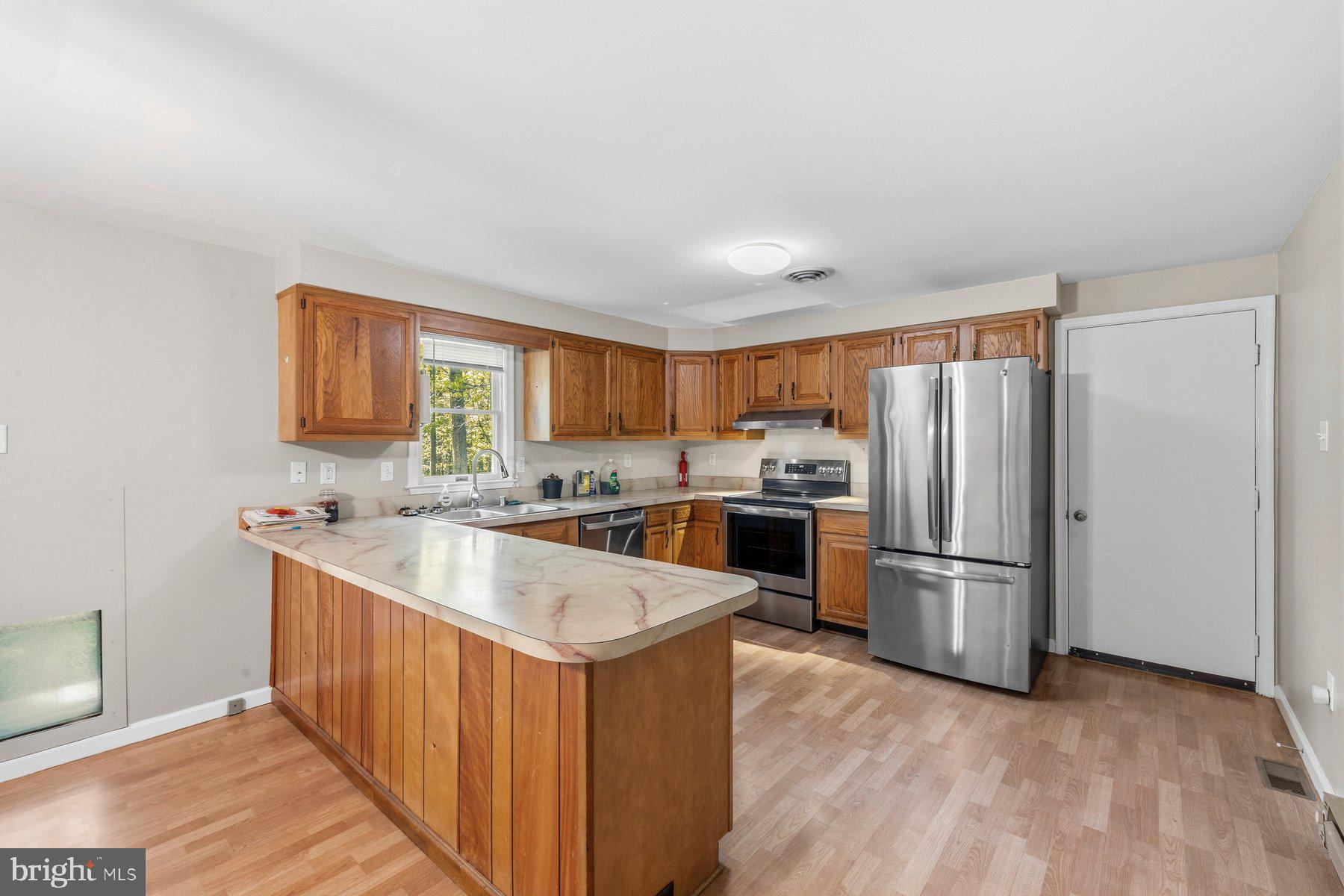 10820 Gambrill Park Road Frederick, MD 21702 - Photo 14 of 35 Modern kitchen with warm wood accents.