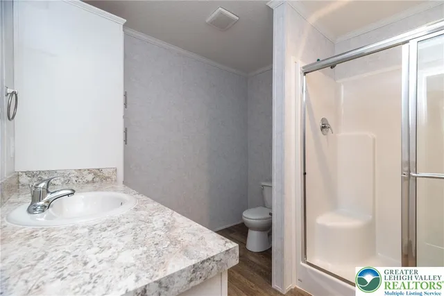 a bathroom with a sink toilet and shower
