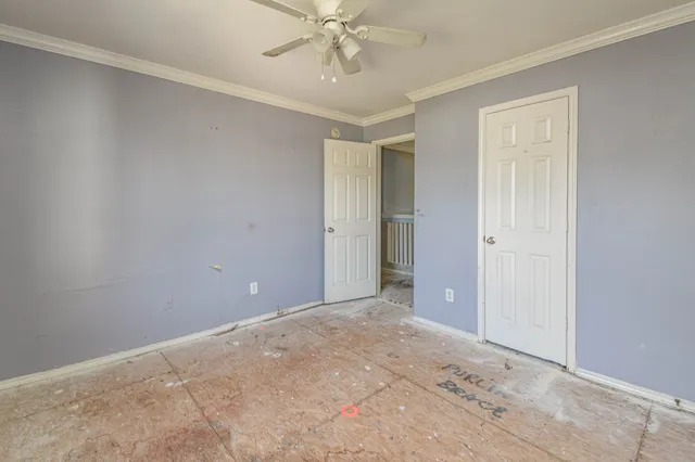 en empty room with fan and a window