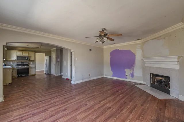 a view of an empty room and fire place