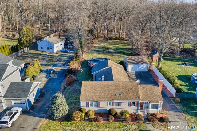 an aerial view of a house with swimming pool garden and patio