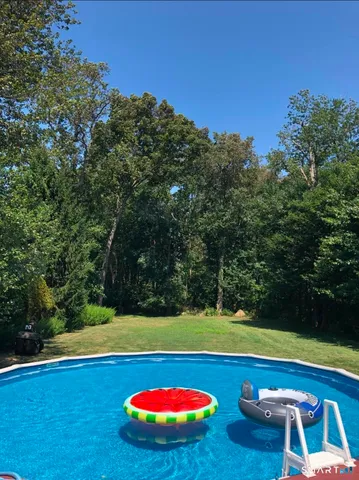 a view of swimming pool with an outdoor space and seating area