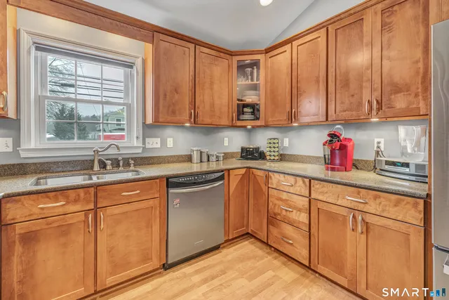 a kitchen with cabinets appliances and a sink