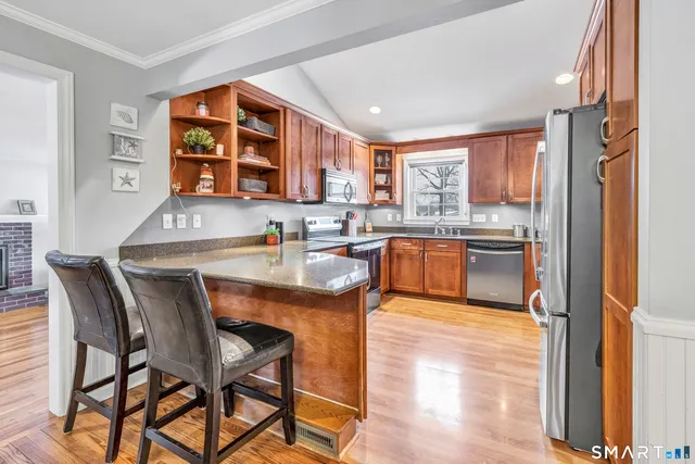 a kitchen with a table chairs sink and cabinets