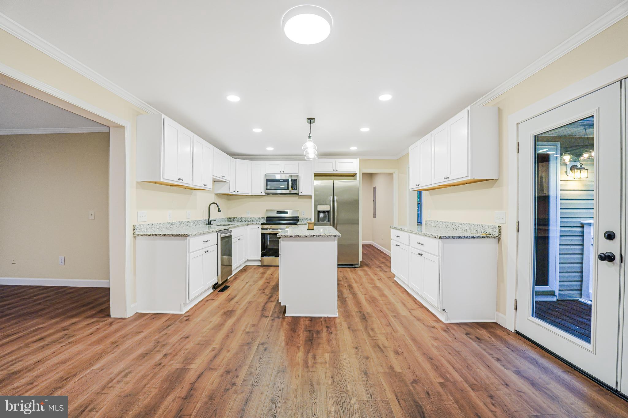 767 Loving Road Zion Crossroads, VA 22942 - Photo 4 of 33 a kitchen with a refrigerator and wooden floor