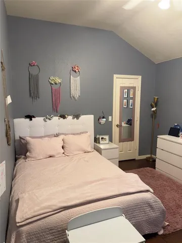 a bedroom with a bed and ceiling fan