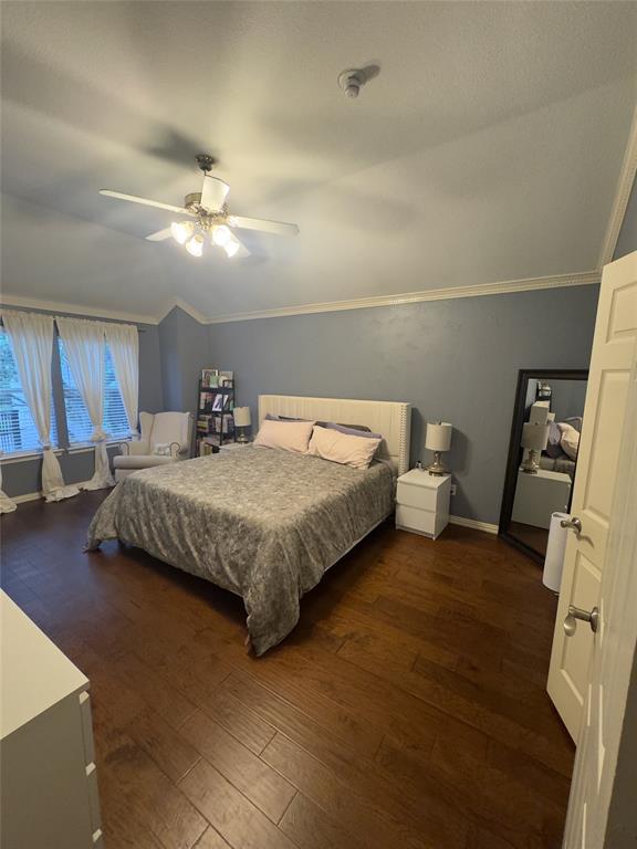 413 Ridge Meade Drive Lewisville, TX 75067 - Photo 16 of 23 a bedroom with a bed and ceiling fan