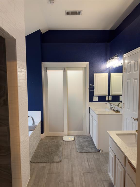 413 Ridge Meade Drive Lewisville, TX 75067 - Photo 17 of 23 a bathroom with a sink a toilet and mirror