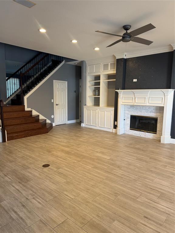 413 Ridge Meade Drive Lewisville, TX 75067 - Photo 22 of 23 a view of a livingroom with a fireplace a ceiling fan and staircase