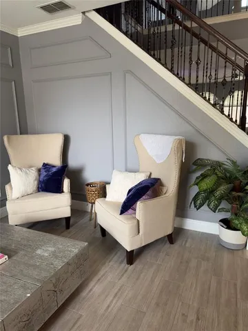 a living room with furniture and wooden floor