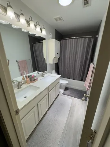 a spacious bathroom with a double vanity sink and a mirror