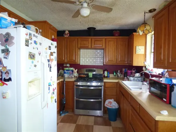 a living room with furniture a window and a potted plant