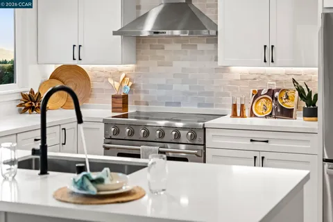 a kitchen with a table chairs refrigerator and microwave