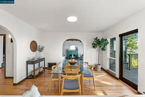 a living room with furniture flowerpot and wooden floor