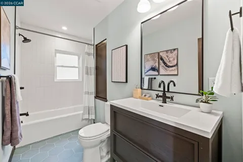 a bathroom with a tub a sink and mirror