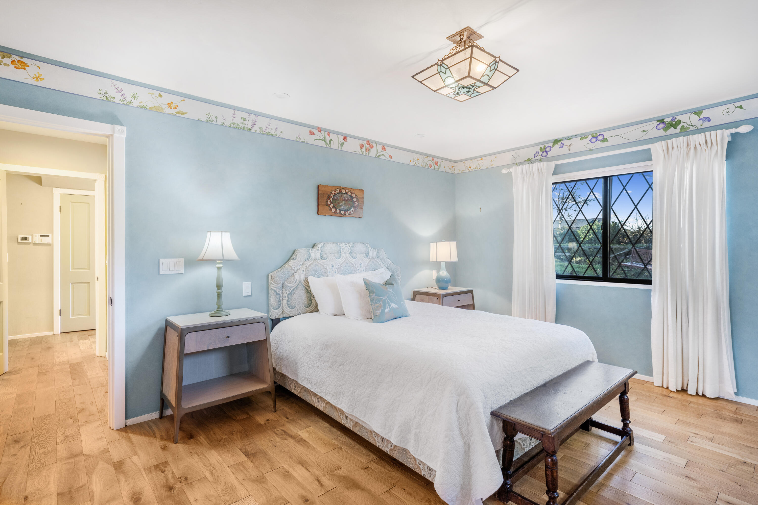 2620 Janin Way Solvang, CA 93463 - Photo 14 of 30 a bedroom with a bed and a chandelier