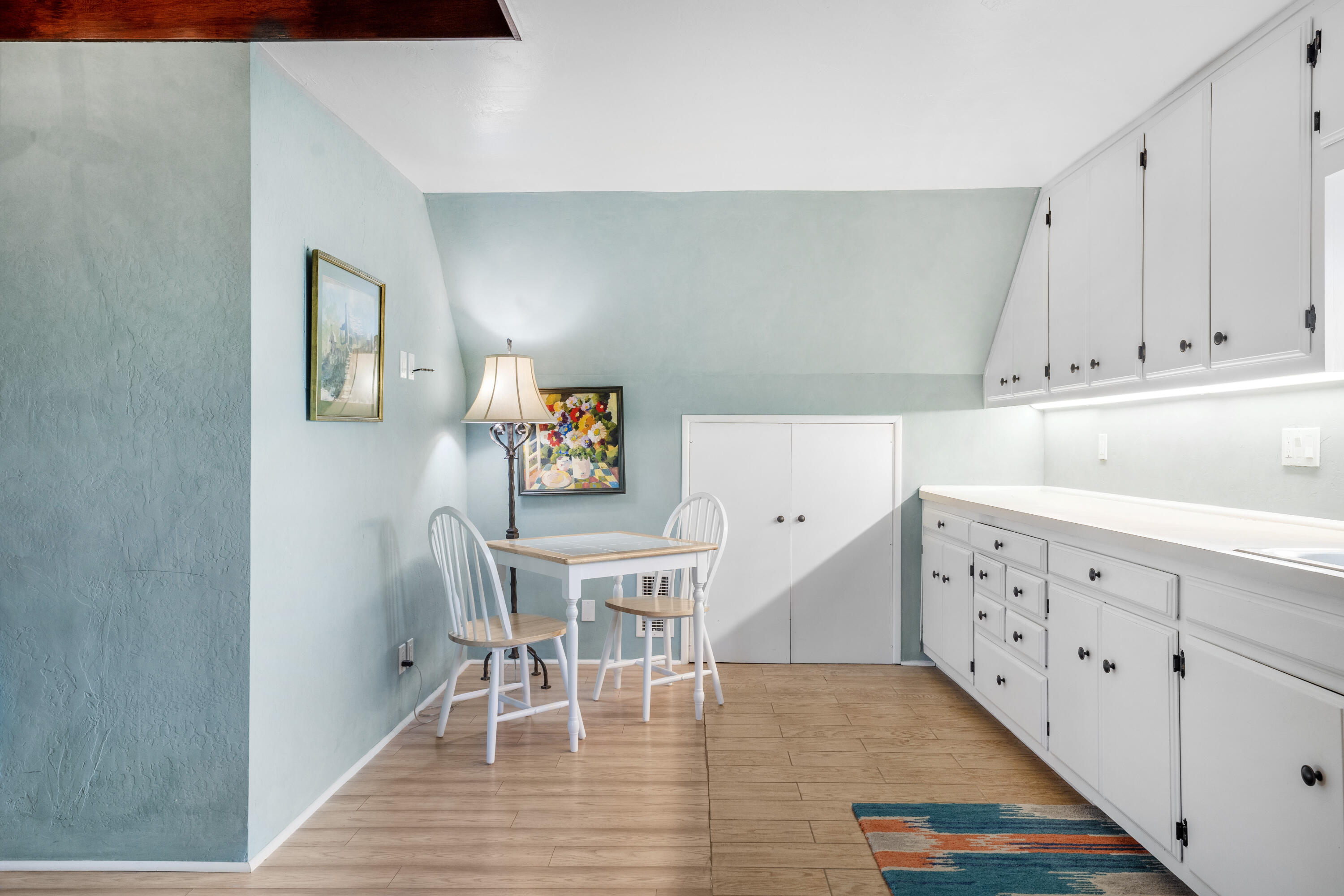 2620 Janin Way Solvang, CA 93463 - Photo 17 of 30 a kitchen with granite countertop a dining table chairs cabinets and wooden floor