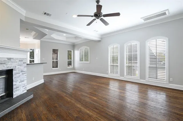 a view of empty room with wooden floor and fireplace
