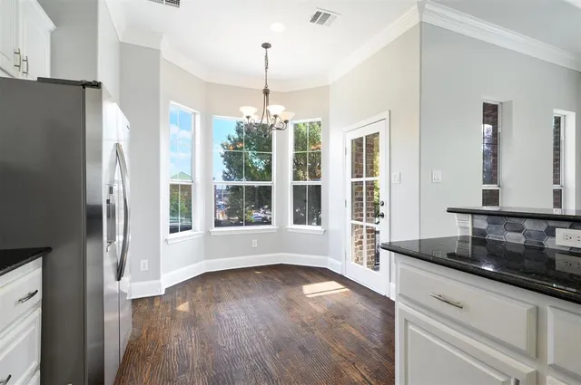 a white toilet sitting next to a bathroom sink