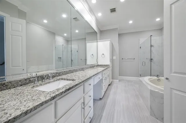a bathroom with a tub sink shower and mirror