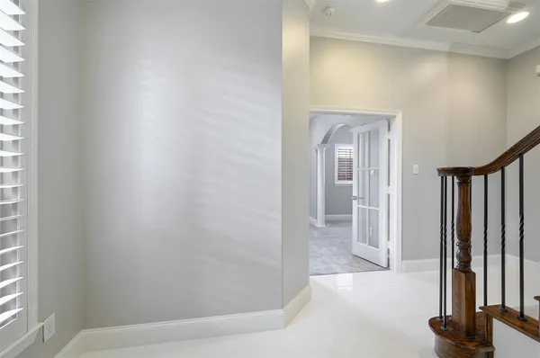 a view of a hallway with wooden floor and staircase