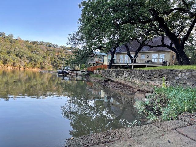 602 Sycamore Road Burnet, TX 78611 - Photo 6 of 26 a backyard of a house with large trees and outdoor seating