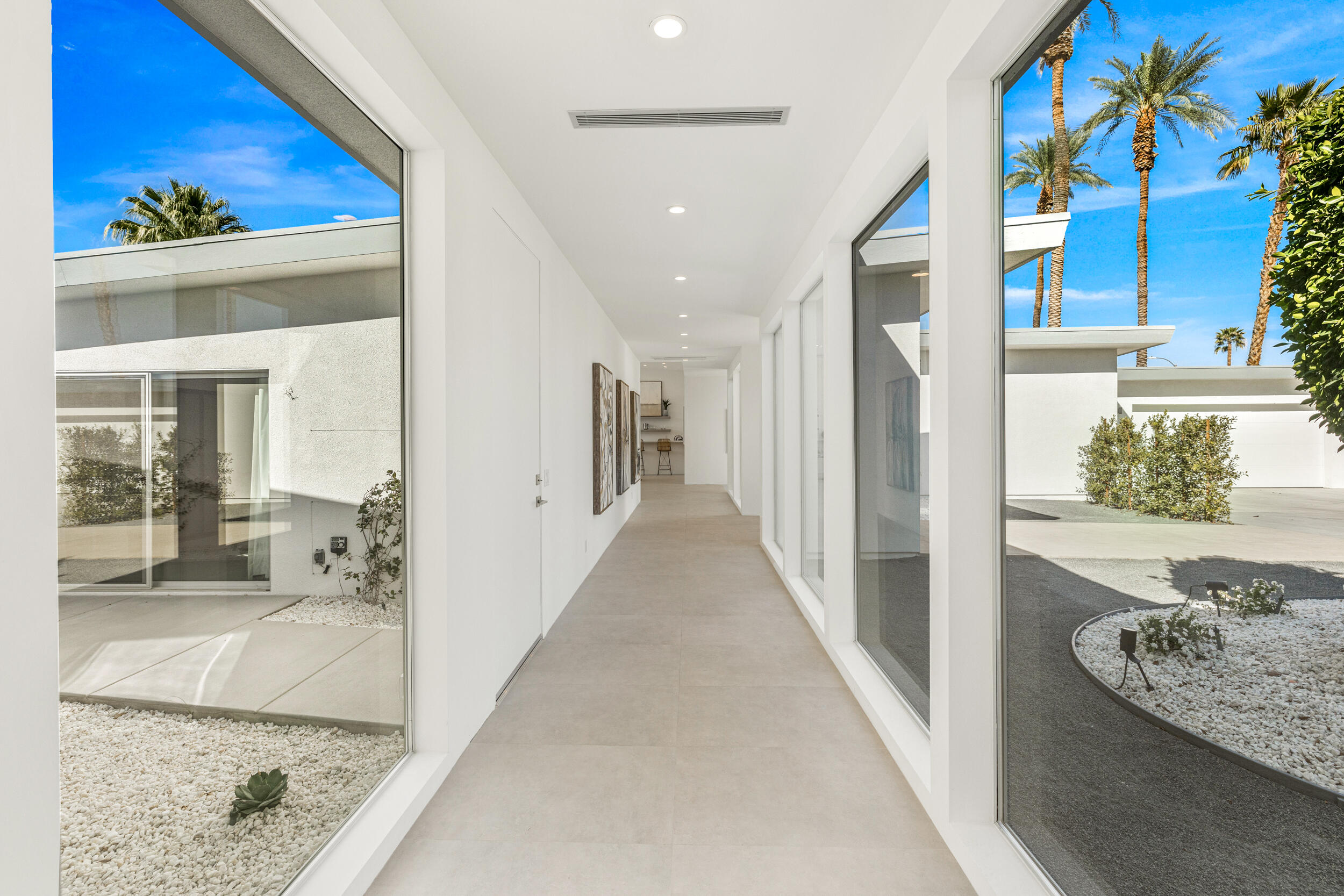 37521 Palm View Road Rancho Mirage, CA 92270 - Photo 16 of 61 a view of a hallway with a dining table and chairs