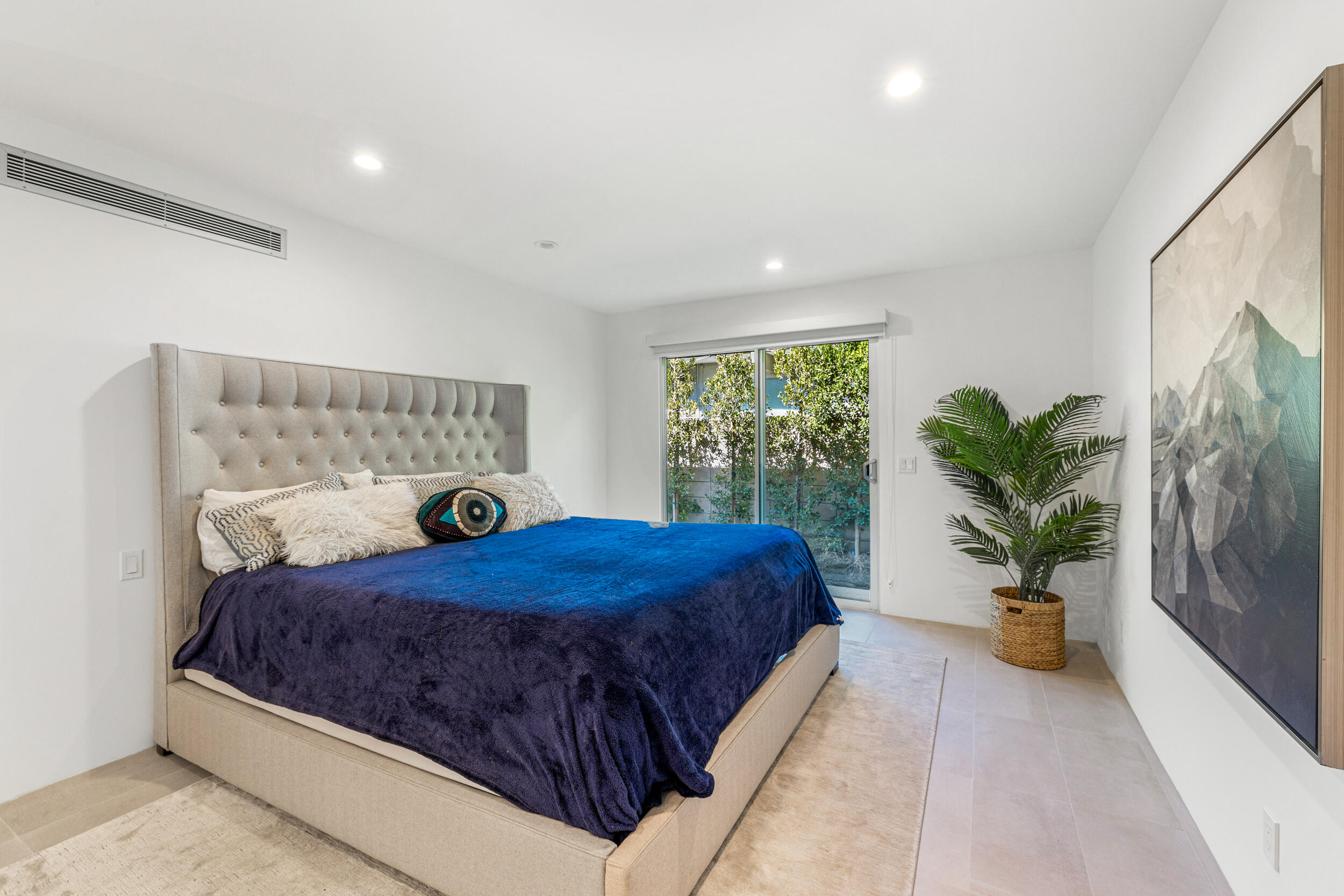37521 Palm View Road Rancho Mirage, CA 92270 - Photo 27 of 61 a bedroom with a large bed and a potted plant