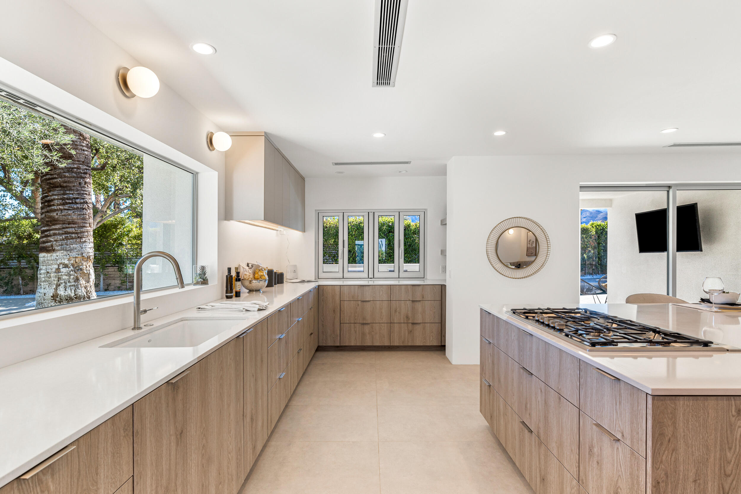 37521 Palm View Road Rancho Mirage, CA 92270 - Photo 4 of 61 a white kitchen with a stove and a large window
